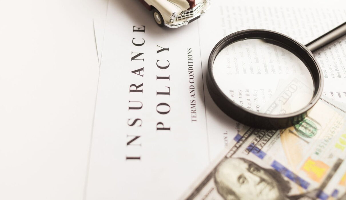 Insurance Claim Disputes illustration showing a policyholder reviewing a denied insurance claim with legal documents and an insurance representative.