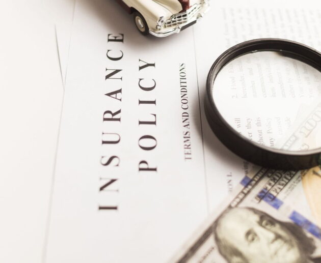 Insurance Claim Disputes illustration showing a policyholder reviewing a denied insurance claim with legal documents and an insurance representative.