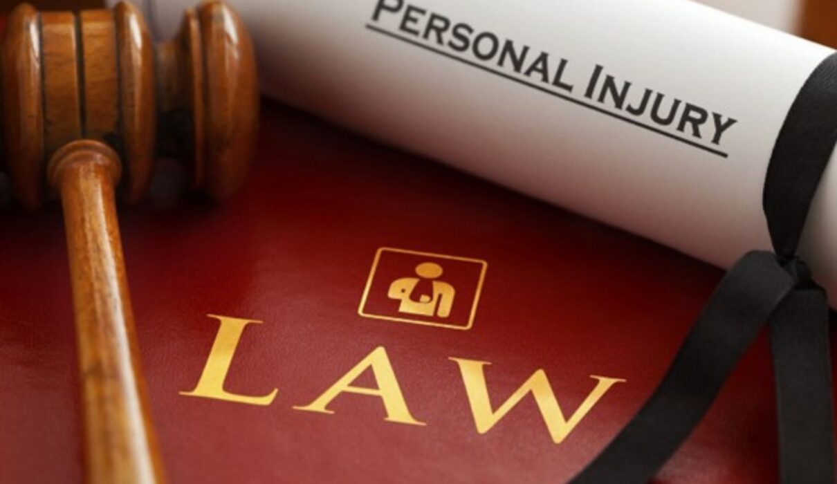 Attorney reviewing documents with an injured client during a consultation about Personal Injury Claims and legal compensation.