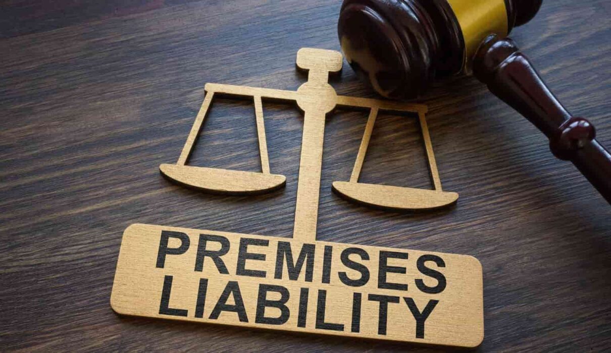 Premises liability cases concept showing a person slipping and falling on a wet floor inside a commercial property, with a warning sign nearby and a legal document in the background.