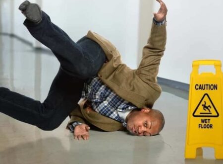 Person slipping on a wet floor in a public building, illustrating common causes of Slip and Fall Accidents.