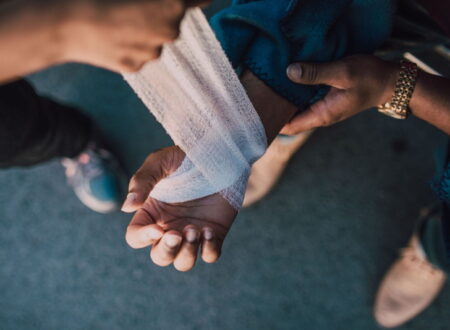 Construction worker receiving medical attention after a job site accident, representing Workplace Injury Claims and workers' compensation rights.
