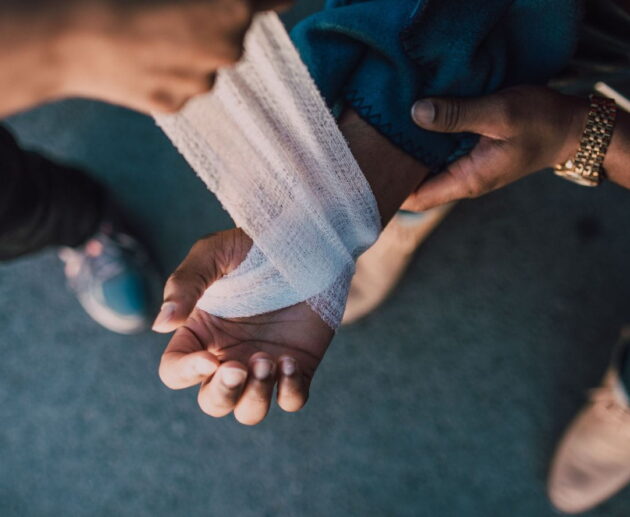 Construction worker receiving medical attention after a job site accident, representing Workplace Injury Claims and workers' compensation rights.
