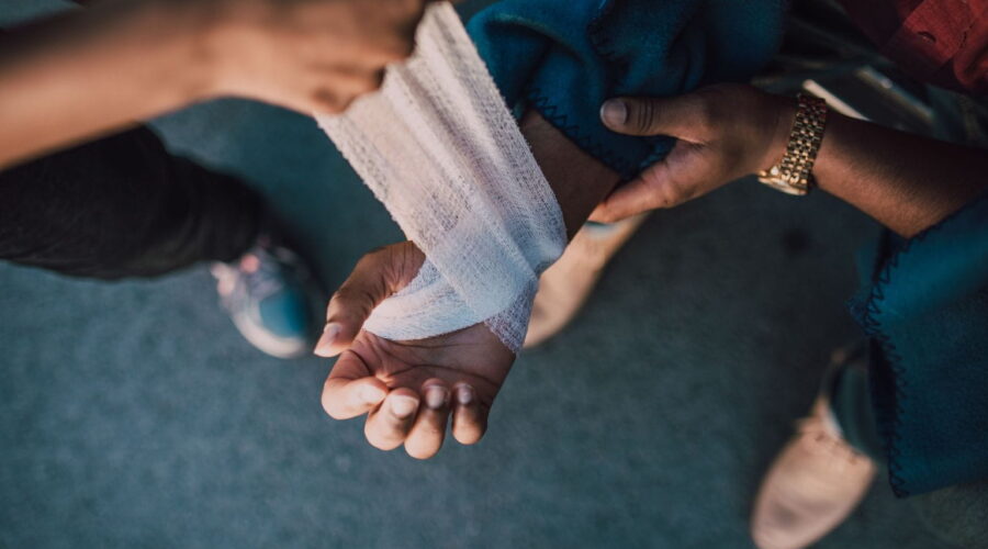 Construction worker receiving medical attention after a job site accident, representing Workplace Injury Claims and workers' compensation rights.