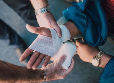 A lawyer reviews legal documents with an injured client during a personal injury case consultation after an accident.