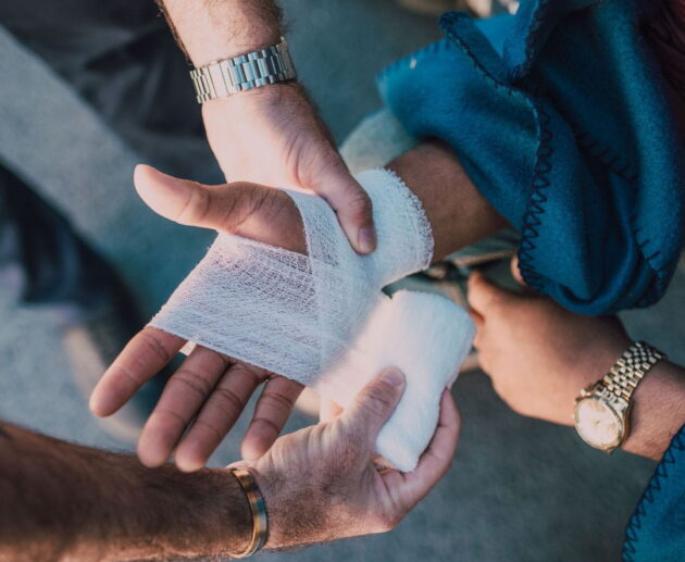 A lawyer reviews legal documents with an injured client during a personal injury case consultation after an accident.