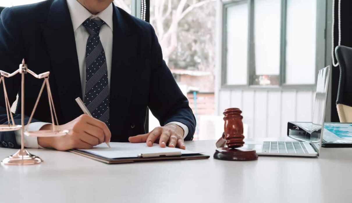 Personal injury lawyer reviewing accident case documents and legal evidence while consulting with a client about an injury claim.