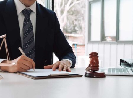 Personal injury lawyer reviewing accident case documents and legal evidence while consulting with a client about an injury claim.