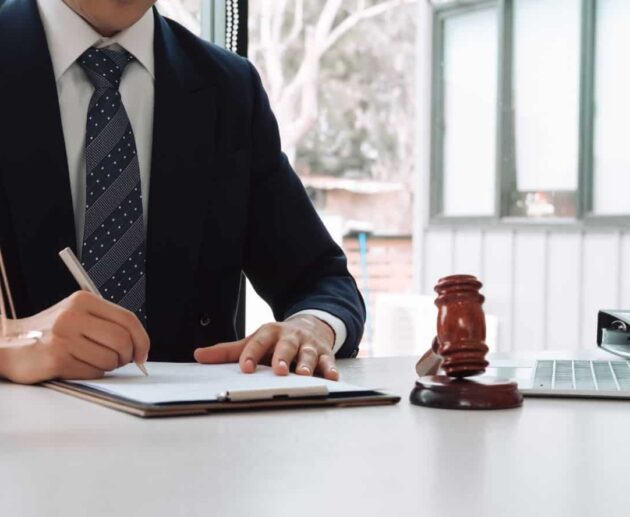 Personal injury lawyer reviewing accident case documents and legal evidence while consulting with a client about an injury claim.