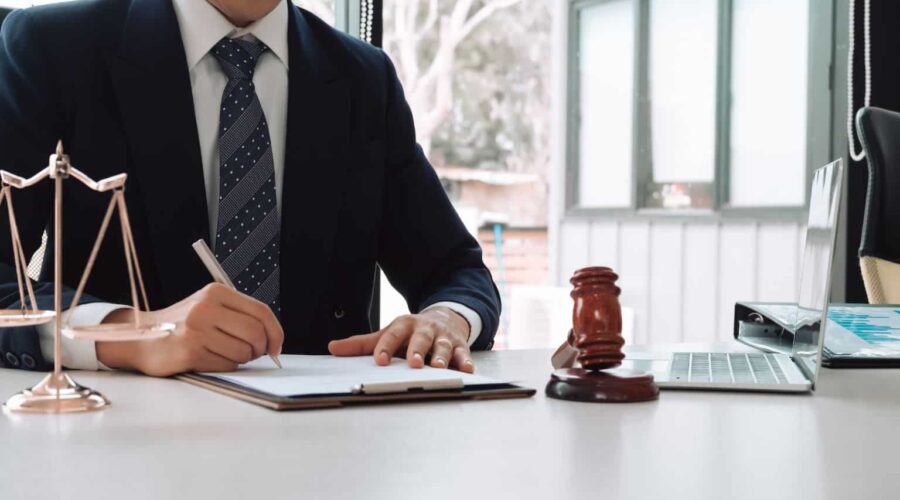 Personal injury lawyer reviewing accident case documents and legal evidence while consulting with a client about an injury claim.