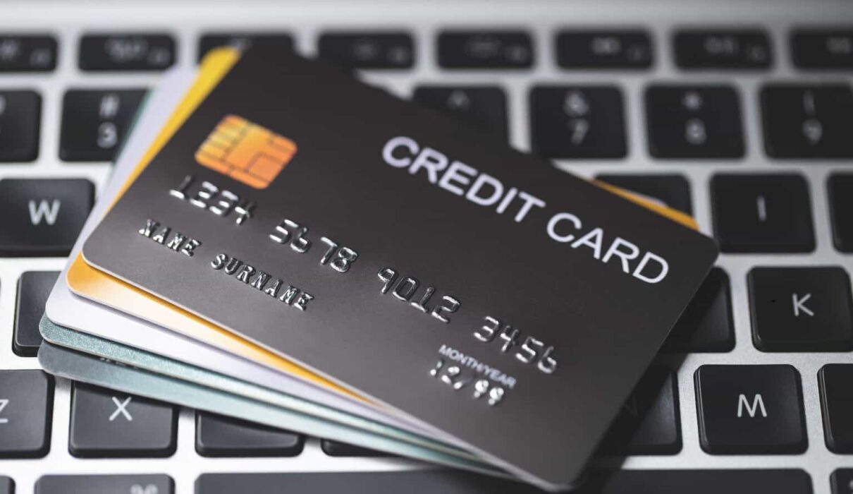 Credit Card Lawsuit showing a consumer reviewing credit card statements and legal documents while consulting with an attorney over a financial dispute.