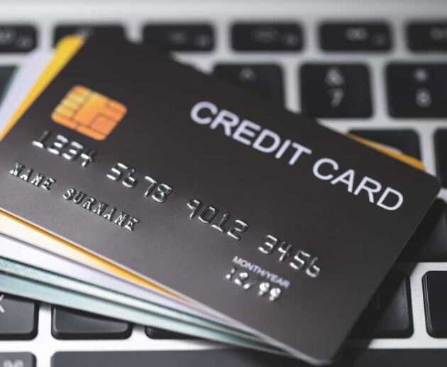 Credit Card Lawsuit showing a consumer reviewing credit card statements and legal documents while consulting with an attorney over a financial dispute.