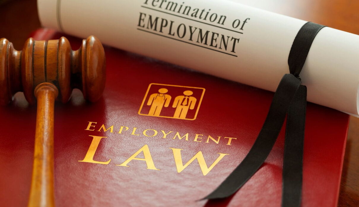 Employment Lawsuit involving an employee and employer reviewing legal documents during a workplace dispute over wrongful termination and workplace rights.