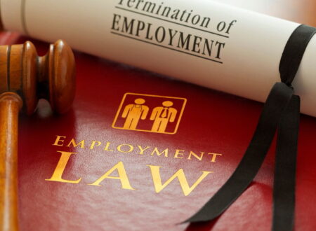 Employment Lawsuit involving an employee and employer reviewing legal documents during a workplace dispute over wrongful termination and workplace rights.