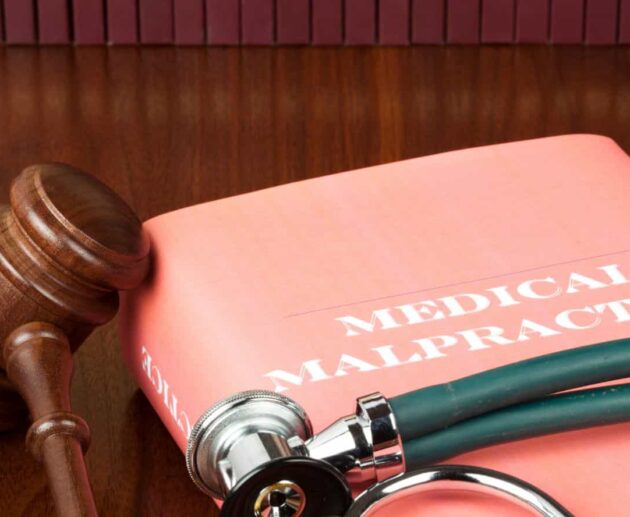 Medical Malpractice Lawsuit consultation between a patient and an attorney reviewing medical records and legal documents related to a healthcare negligence claim.