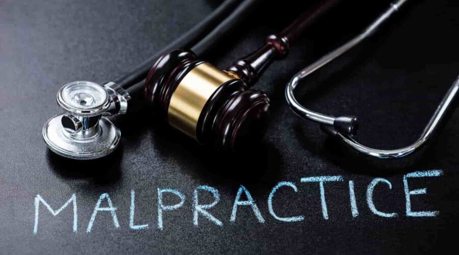 Medical malpractice compensation consultation between an injured patient and attorney reviewing medical records and legal documents.
