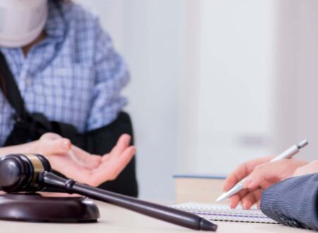 Personal Injury Lawsuit attorney consulting with an injured client while reviewing legal documents and evidence after an accident.