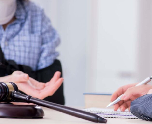 Personal Injury Lawsuit attorney consulting with an injured client while reviewing legal documents and evidence after an accident.