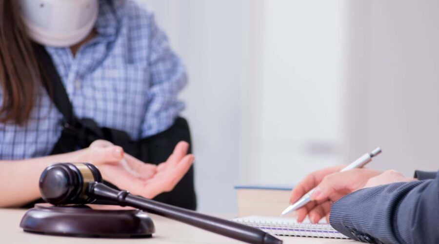 Personal Injury Lawsuit attorney consulting with an injured client while reviewing legal documents and evidence after an accident.
