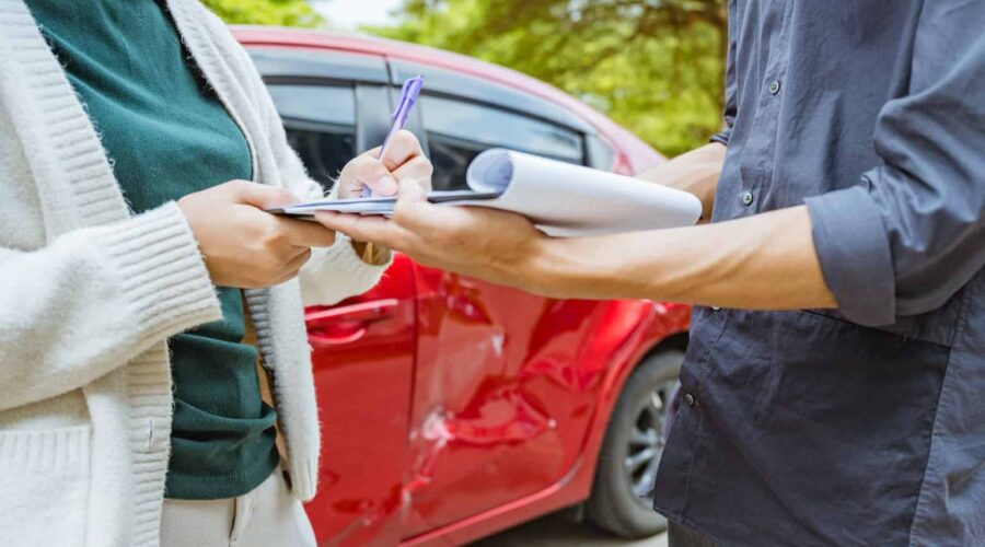 Rideshare Accident Claim involving a damaged rideshare vehicle after a traffic collision, with a passenger reviewing insurance and legal documents.