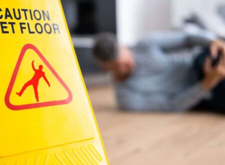 Person slipping on a wet floor in a public building, illustrating common Slip and Fall Accidents that can lead to serious injuries and legal claims.