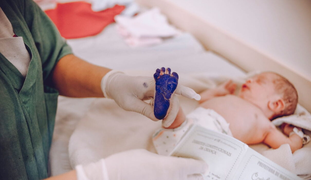 Birth injury lawsuit consultation between parents and an attorney reviewing medical records related to a birth injury lawsuit claim.