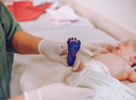 Birth injury lawsuit consultation between parents and an attorney reviewing medical records related to a birth injury lawsuit claim.