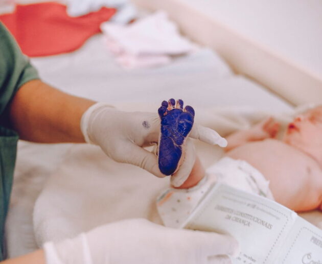 Birth injury lawsuit consultation between parents and an attorney reviewing medical records related to a birth injury lawsuit claim.