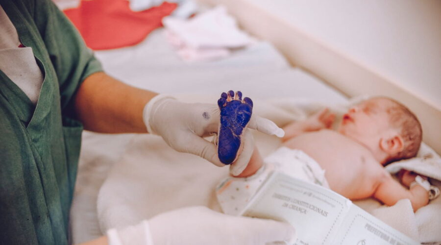 Birth injury lawsuit consultation between parents and an attorney reviewing medical records related to a birth injury lawsuit claim.