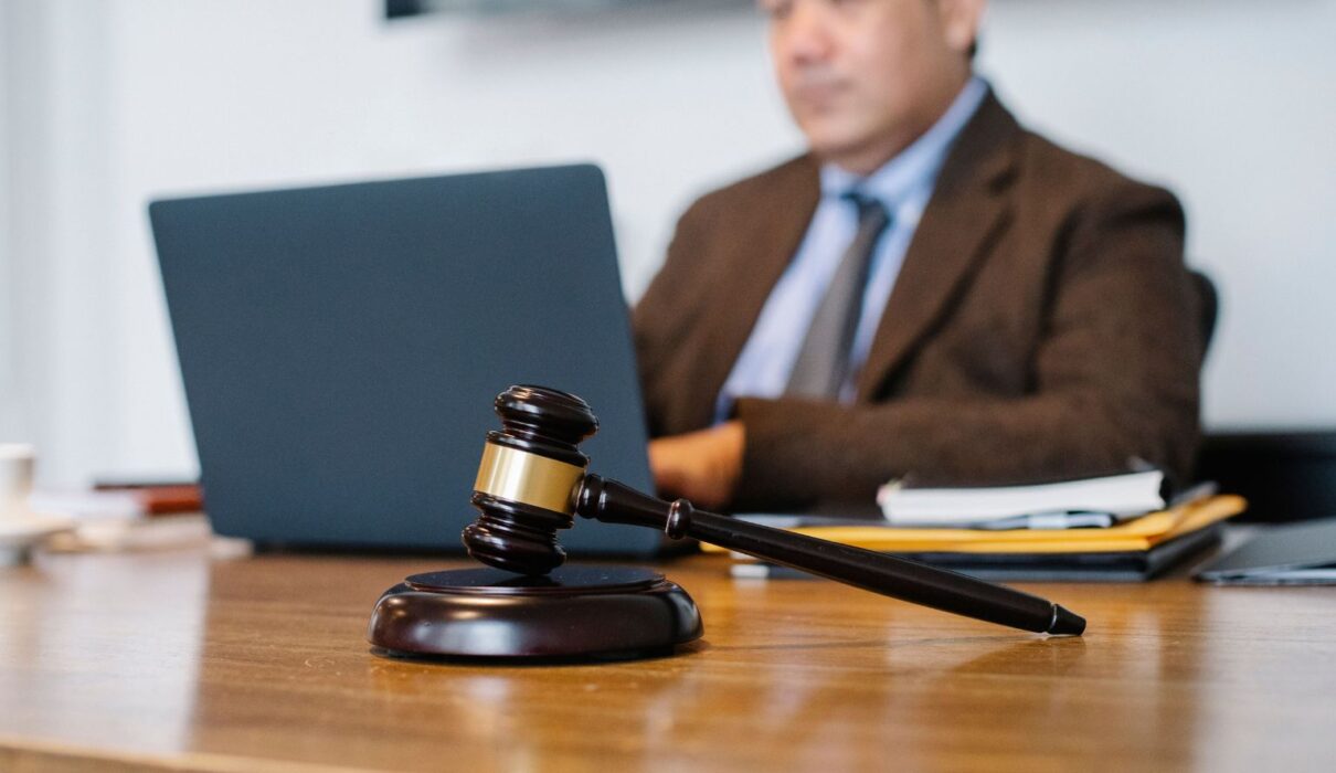 Illustration depicting a HexClad lawsuit with a gavel, legal documents, and cookware products representing consumer protection and product claims.
