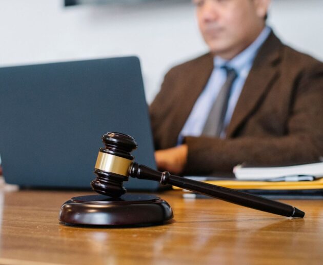 Illustration depicting a HexClad lawsuit with a gavel, legal documents, and cookware products representing consumer protection and product claims.