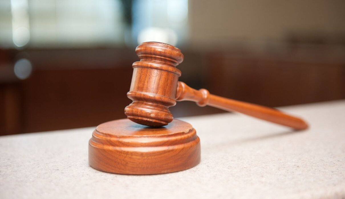 Illustration depicting the Isotonix lawsuit, featuring dietary supplement products, legal documents, a judge's gavel, and consumer protection concerns.
