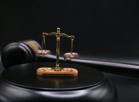 Gavel and scales of justice beside a blockchain network graphic, representing the OtterSec lawsuit over the crypto auditing firm's dissolution.