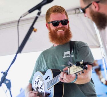 Oliver Anthony performing on stage, country folk singer known for Rich Men North of Richmond