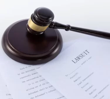 Gavel and legal documents representing the Roundup lawsuit and Bayer settlement proceedings