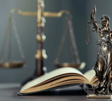 Gavel and legal documents beside a bottle of paraquat herbicide, representing the Paraquat Lawsuit