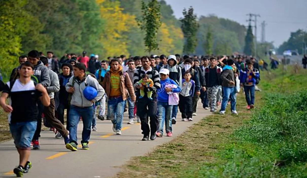 Migrants crossing the border fence between Morocco and the Spanish enclave of Ceuta during the border crisis