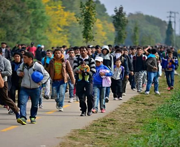 Migrants crossing the border fence between Morocco and the Spanish enclave of Ceuta during the border crisis
