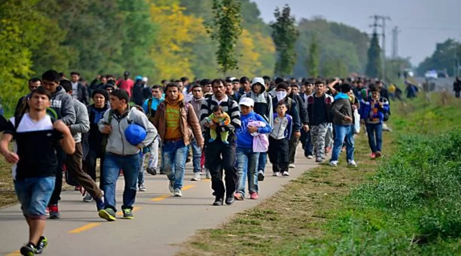 Migrants crossing the border fence between Morocco and the Spanish enclave of Ceuta during the border crisis