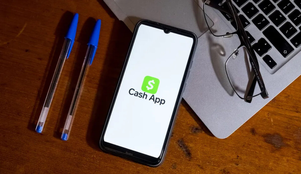 Gavel, scales, and smartphone beside an official settlement notice representing the Cash App lawsuit update