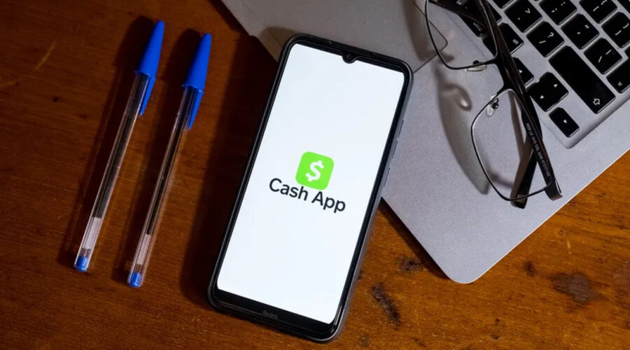 Gavel, scales, and smartphone beside an official settlement notice representing the Cash App lawsuit update