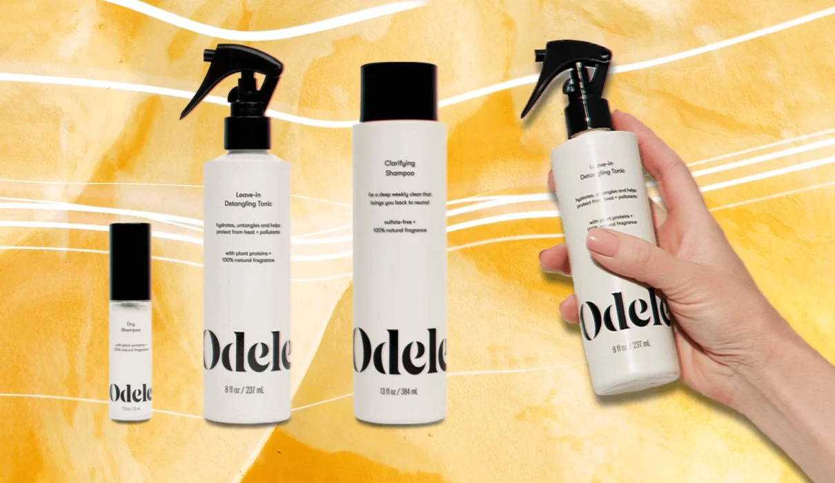 Magnifying glass over a shampoo ingredient list beside an unlabeled bottle, representing Odele shampoo lawsuit research