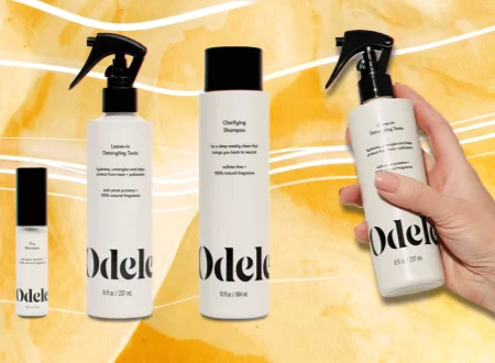 Magnifying glass over a shampoo ingredient list beside an unlabeled bottle, representing Odele shampoo lawsuit research