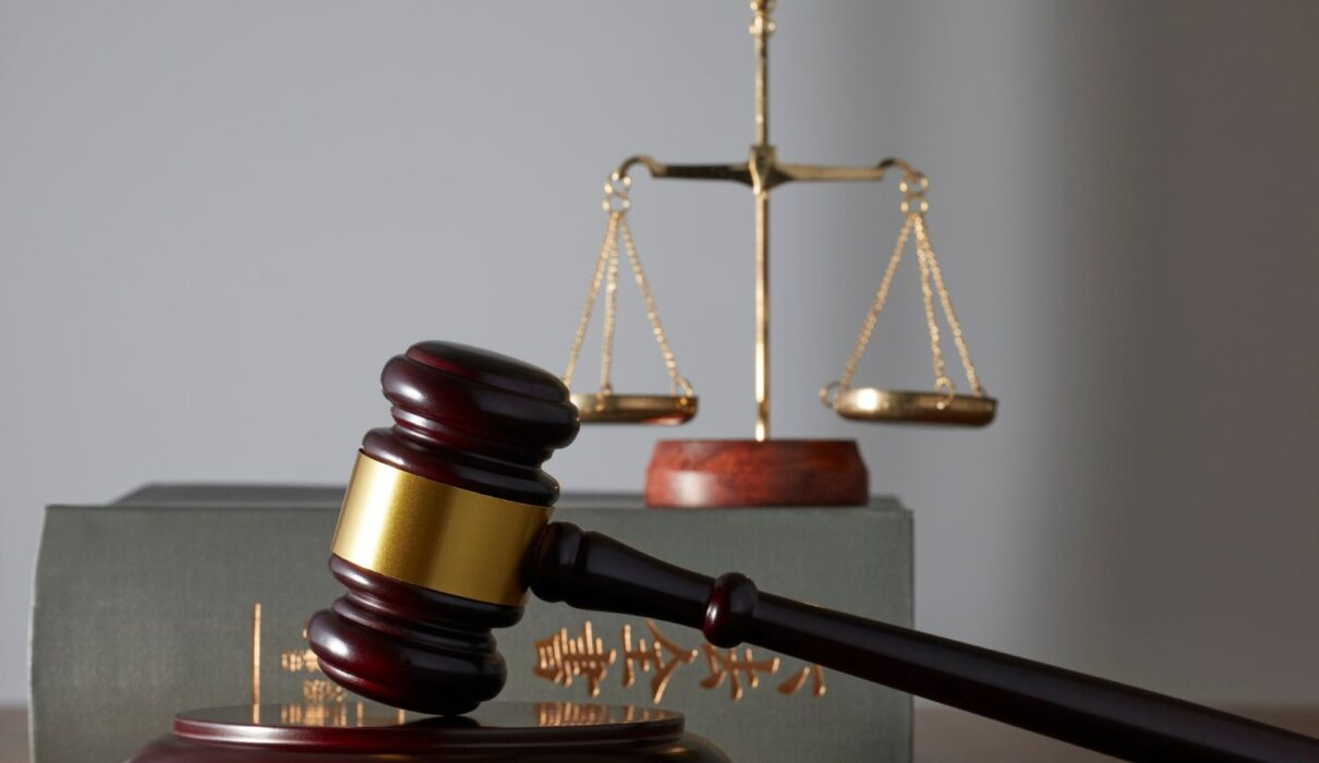Attorney from Prestige Legal Solutions reviewing case documents with a client in a modern office
