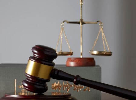 Attorney from Prestige Legal Solutions reviewing case documents with a client in a modern office