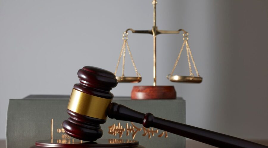 Attorney from Prestige Legal Solutions reviewing case documents with a client in a modern office