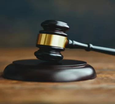 Gavel resting on legal documents in a courtroom