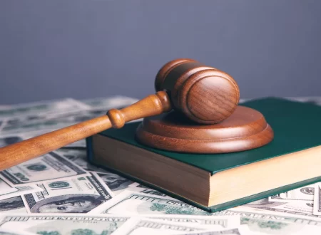 Prenatal vitamin bottle beside a gavel and court documents